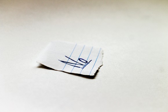 Piece of paper with the word "no" written on it.