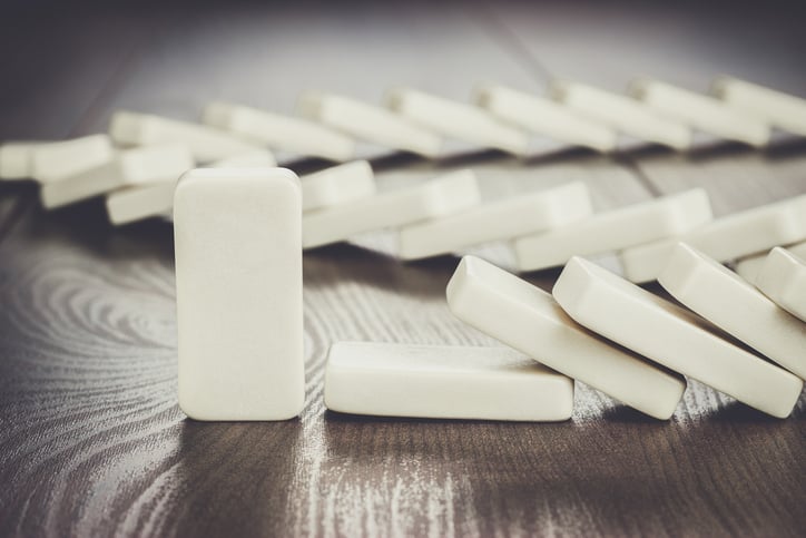 Dominoes falling, except the last one in the set up.