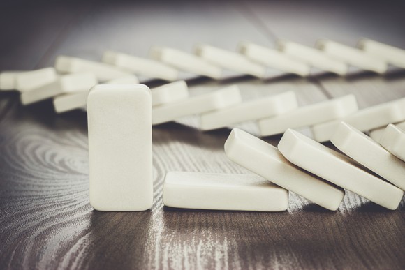 Dominoes falling, except the last one in the set up.