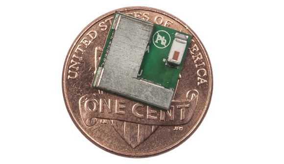 Small semiconductor chip sitting on top of a penny