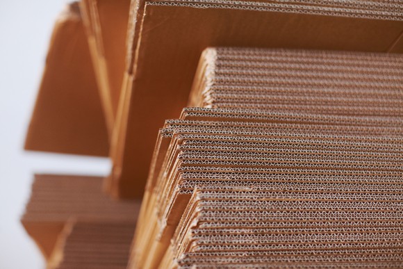 Close-up of clean corrugated cardboard sheets in a stack.