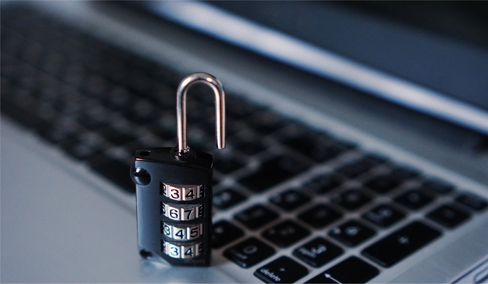 A digital padlock on top of a laptop keyboard.