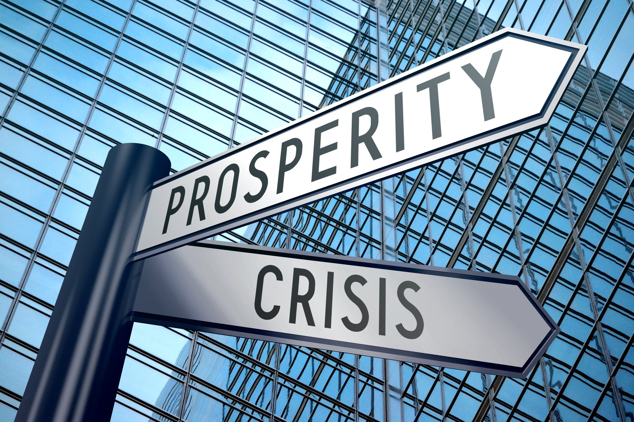 Crisis and prosperity street signs with building in background