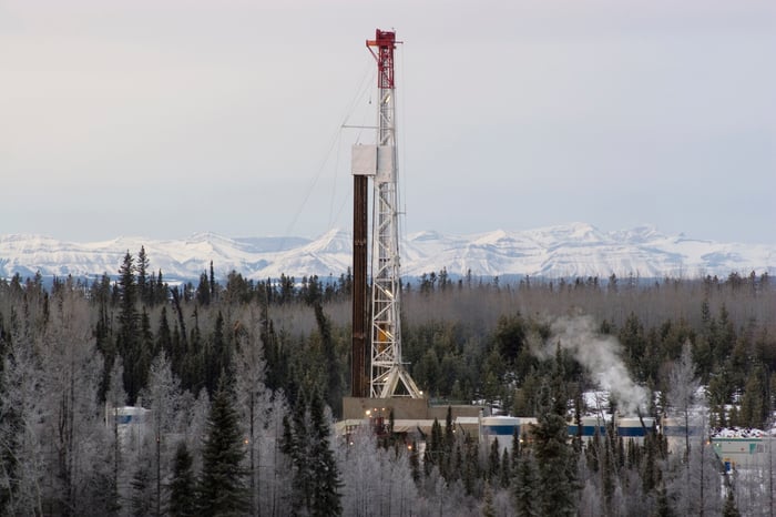 Drilling rig in forest during winter.