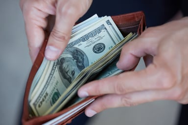 open wallet with hundreds_GettyImages-483292560