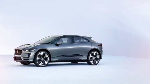 The Jaguar I-PACE in gray gunmetal, displayed in a white room.