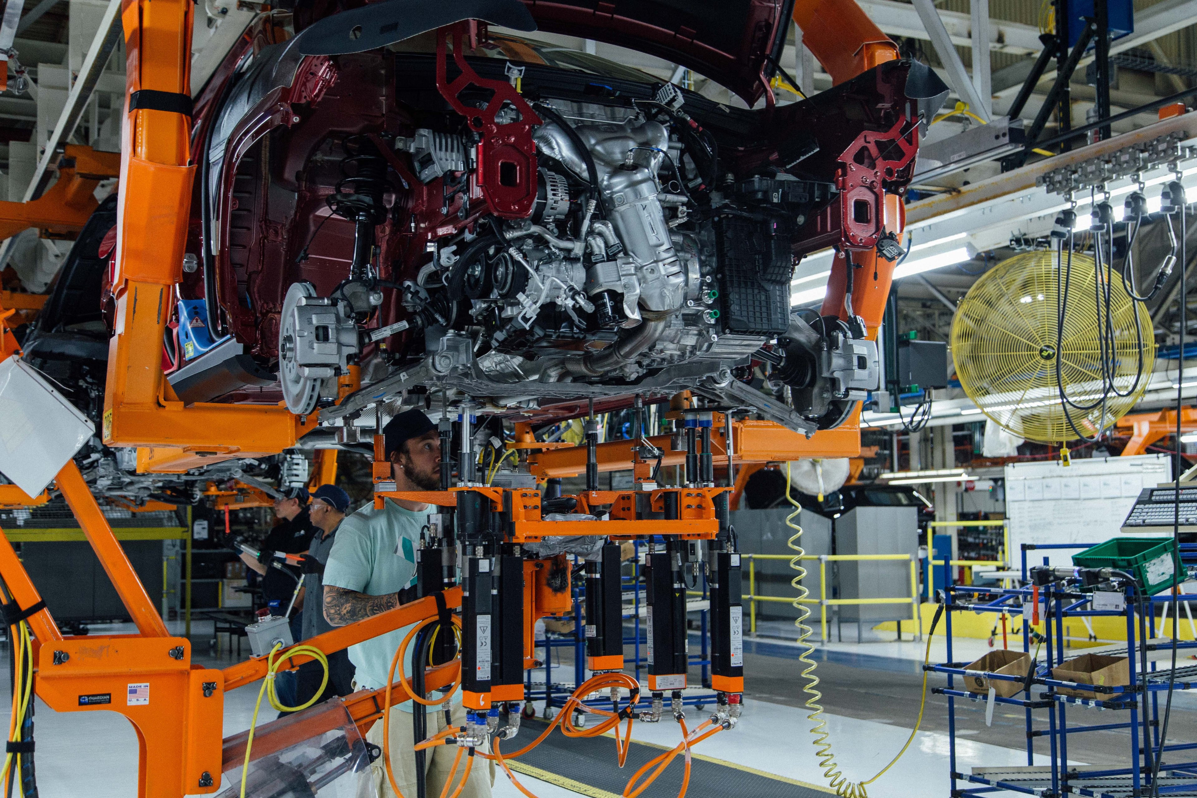 Workers attend to a partially-assembled Jeep Cherokee on the assembly line at FCA's Belvidere Assembly Plant in Belvidere, Illinois. 