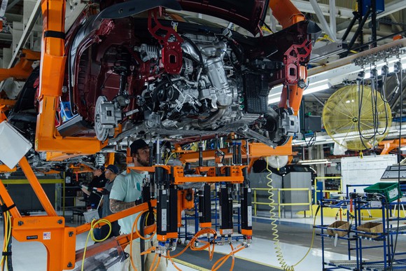 Workers attend to a partially-assembled Jeep Cherokee on the assembly line at FCA's Belvidere Assembly Plant in Belvidere, Illinois. 