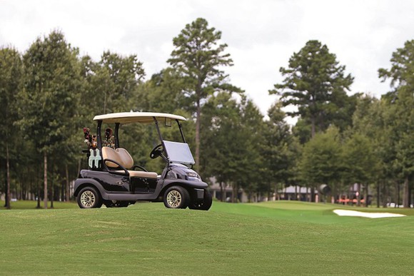 A golf car on a field.