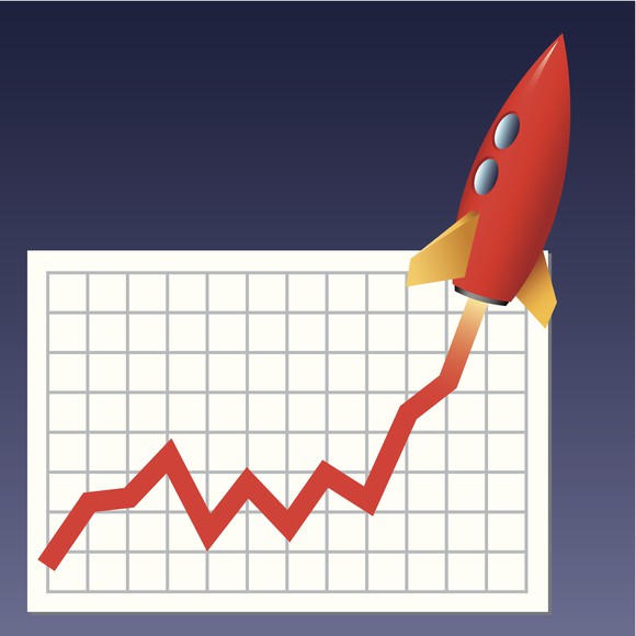 A stock chart with a rocket ship taking off from the chart.