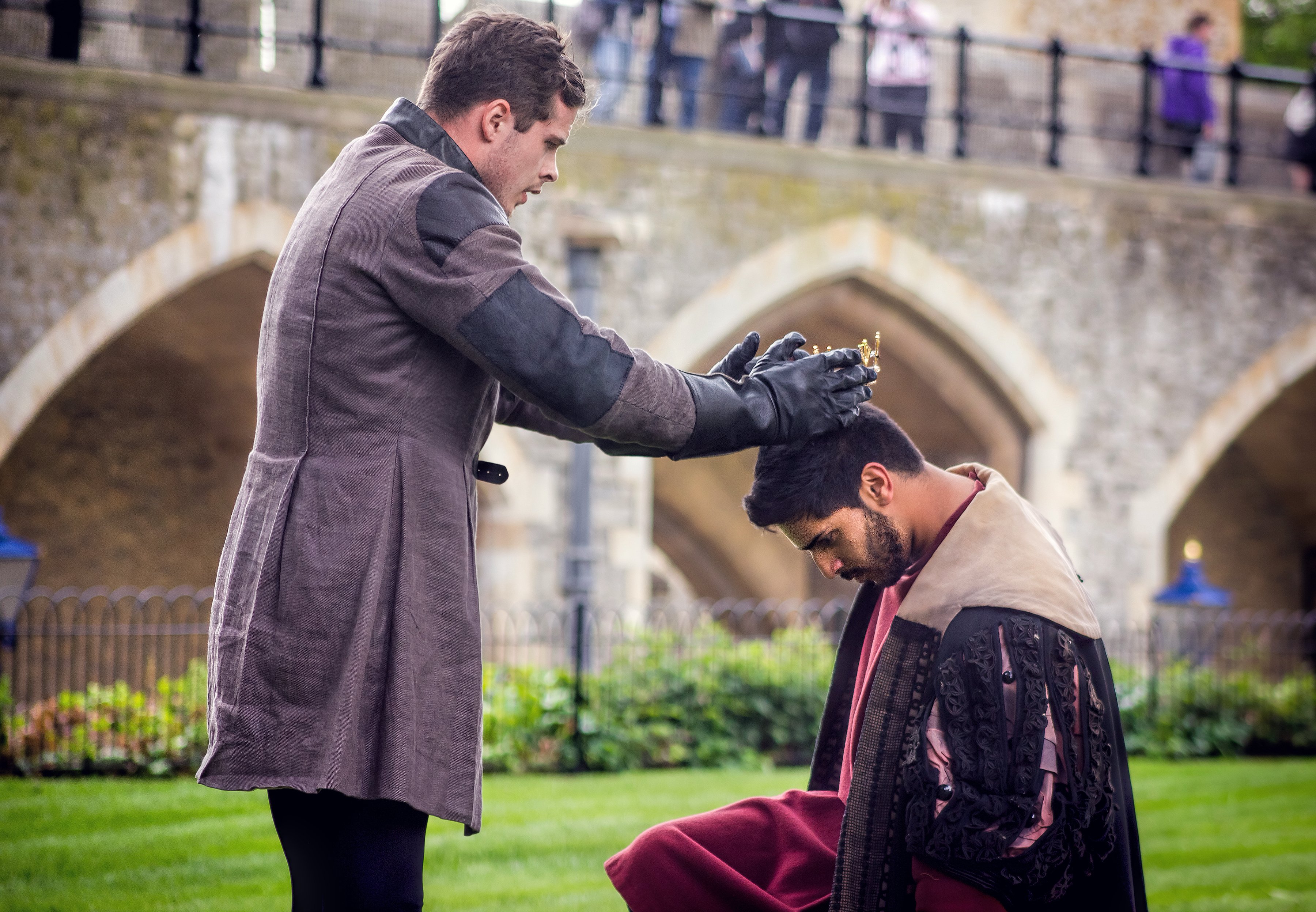 Shakespearean actors acting out the crowning of the king.