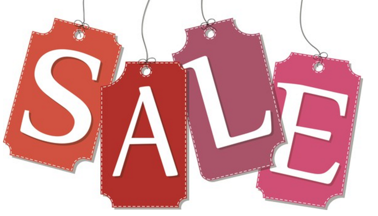 Hanging tags with letters on them spell out the word sale.