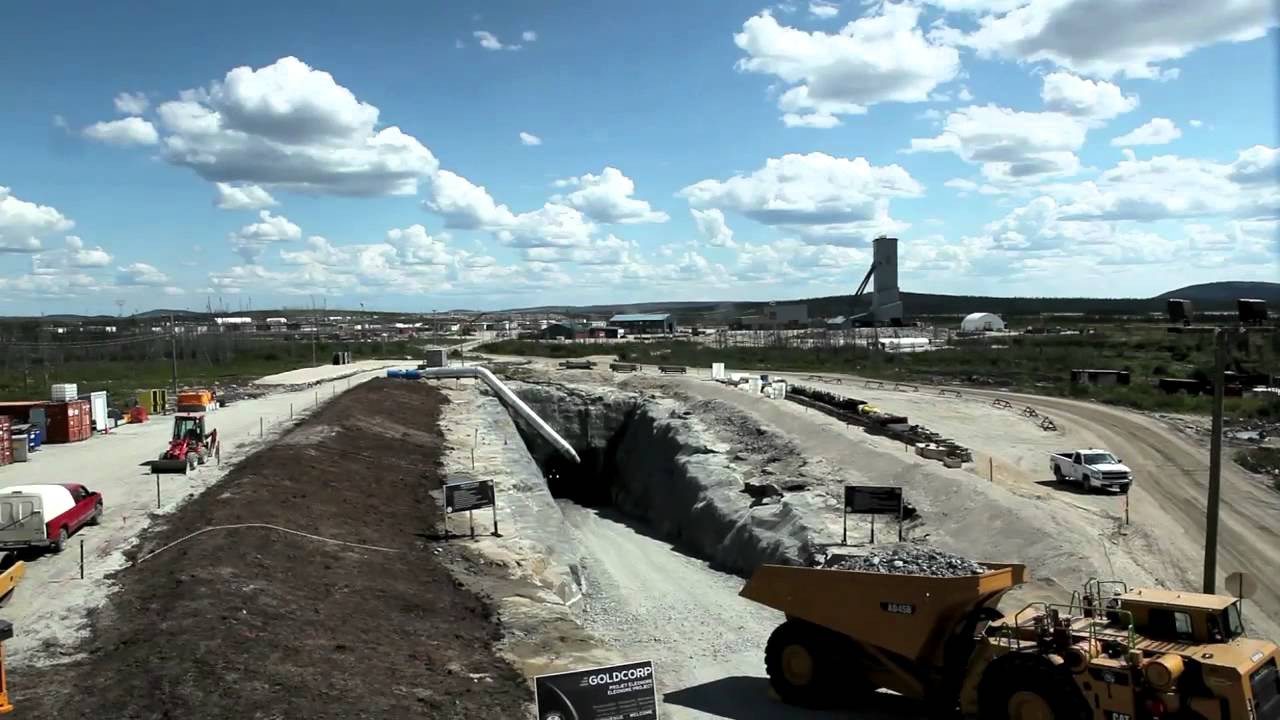 Goldcorp mining operation in an arid landscape under a partly cloudy blue sky.