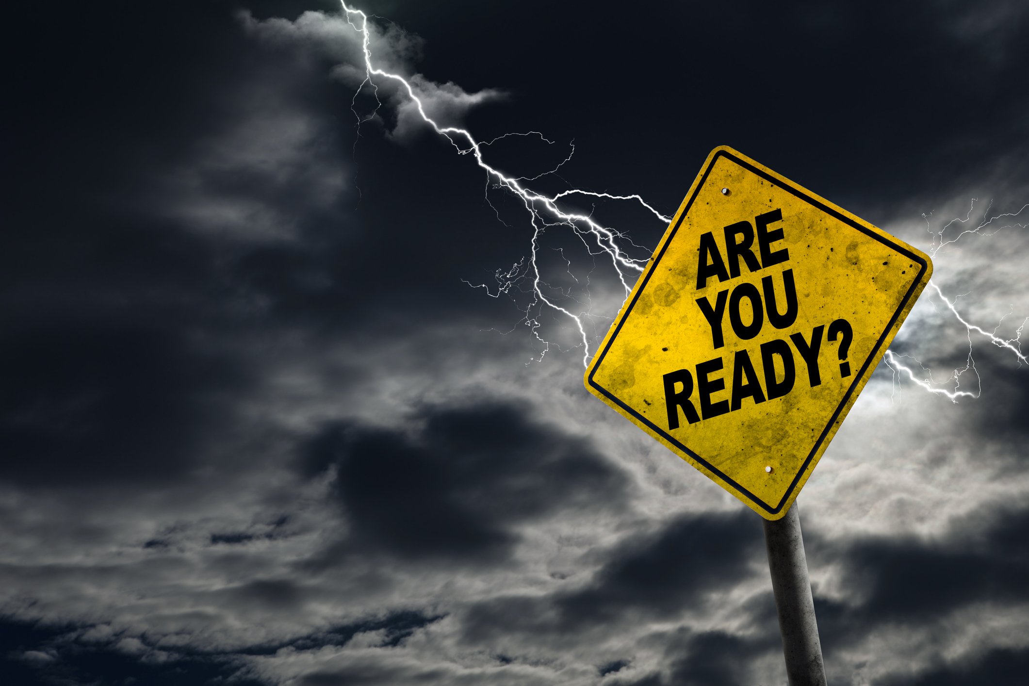 Traffic sign against a dark sky reading are you ready?