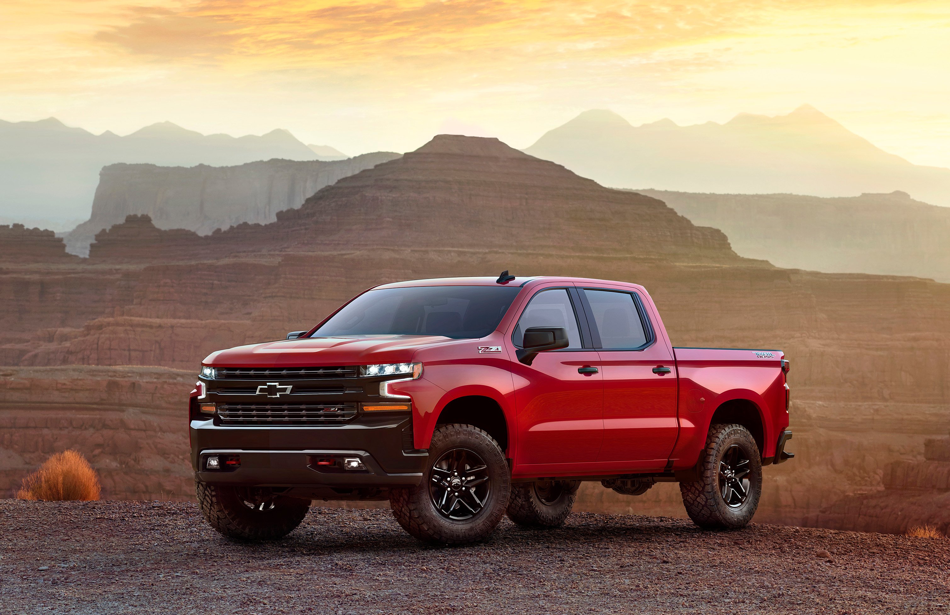A red 2019 Chevrolet Silverado pickup truck in a desert setting.
