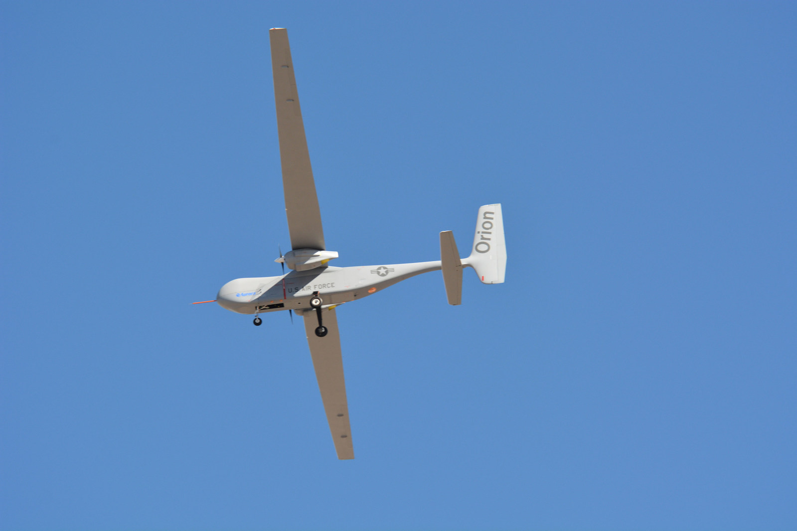 Orion drone in flight against a clear blue sky
