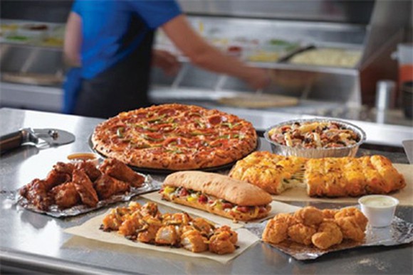 A display of Domino's menu items including pizza, chicken wings, and breadsticks