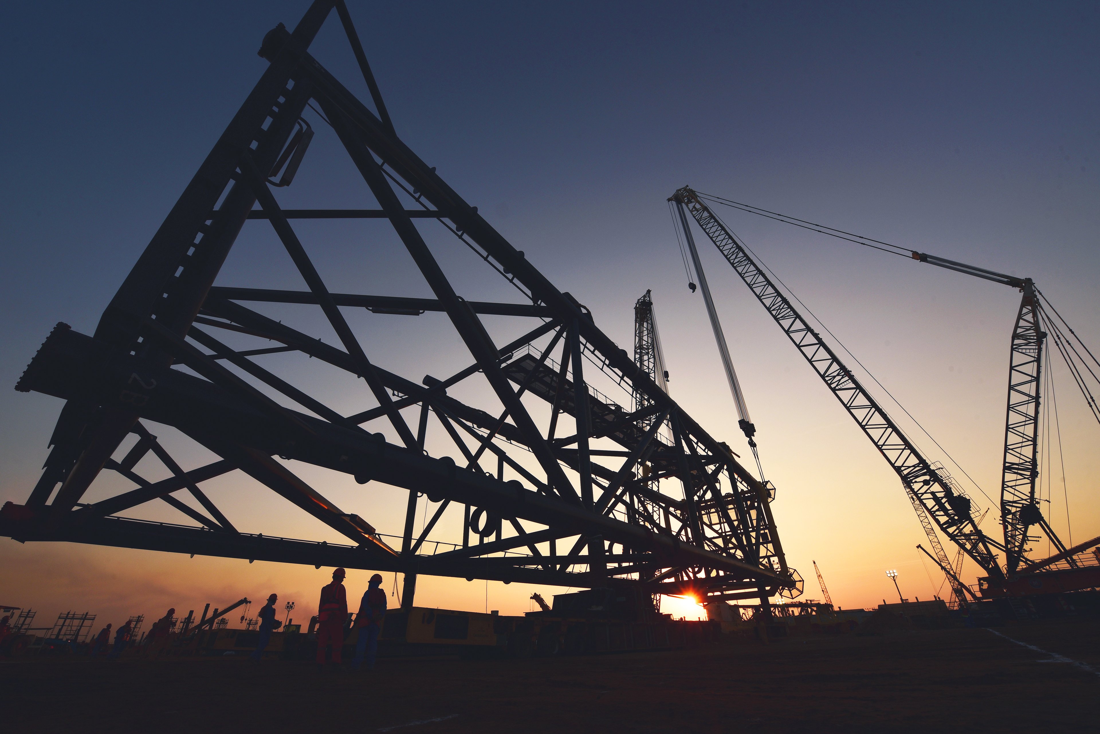 Assembling an offshore jacket at sunset.
