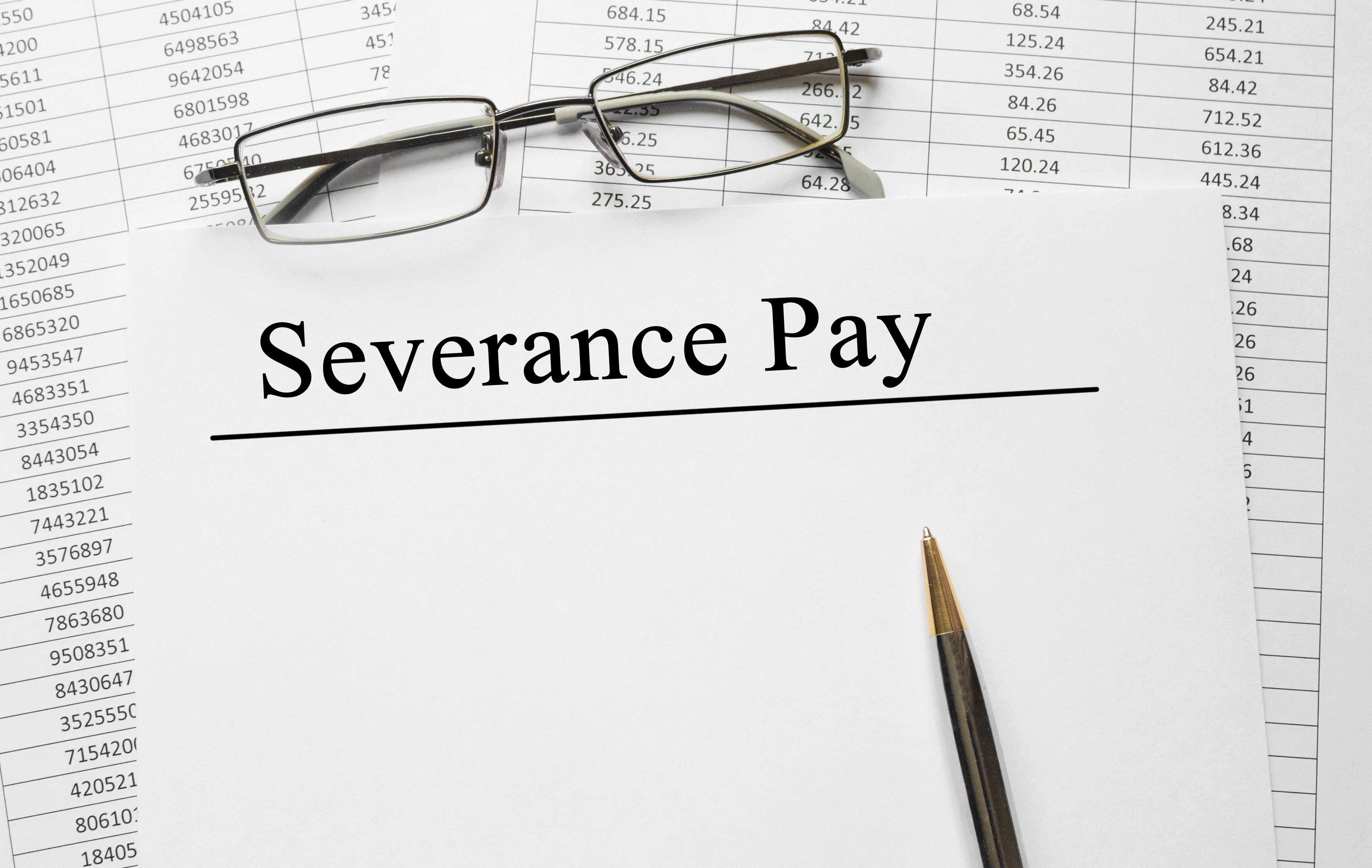 Severance pay document with tables behind it