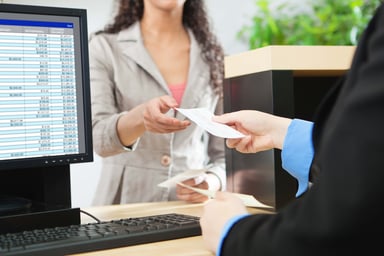 Teller handing a customer a check