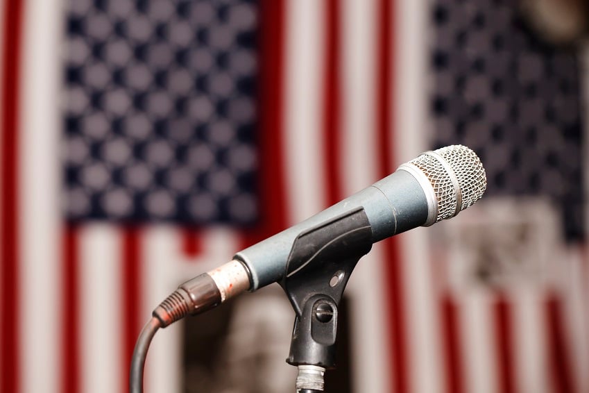Microphone in front of two American flags