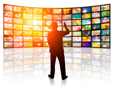 man_in_front_of_many_screens