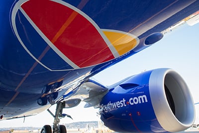 The underside of a blue Southwest Airlines Boeing 737, displaying the company name and heart shaped logo.