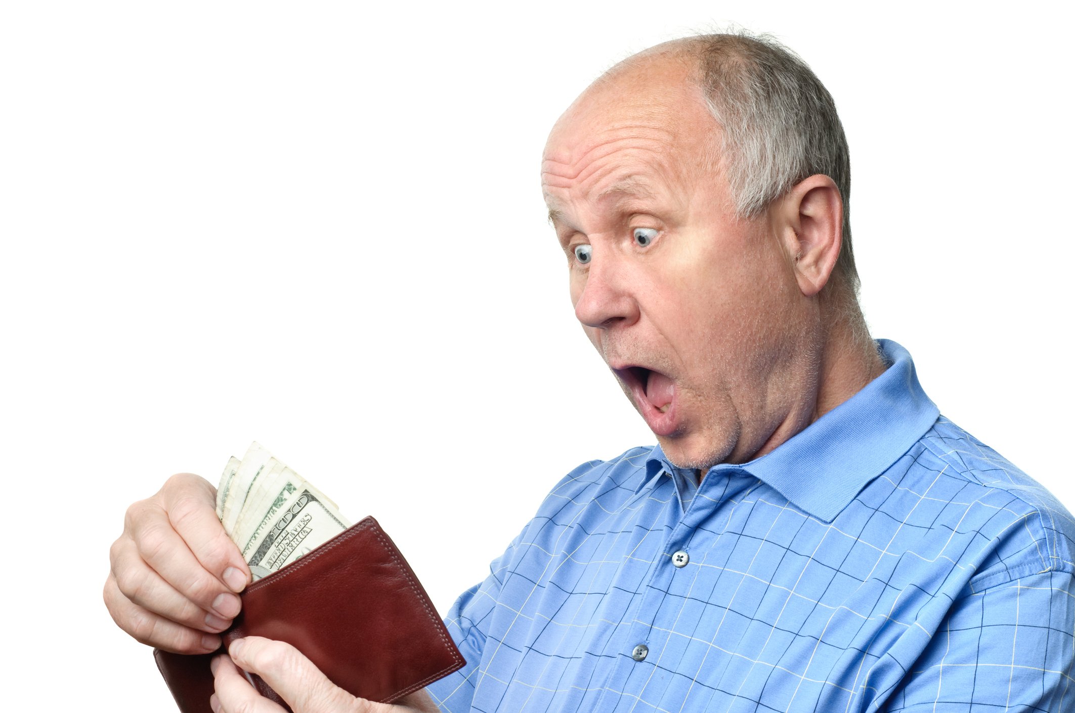 A surprised senior man looking at cash in his wallet.