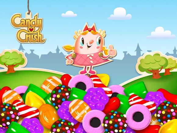 A girl character from Candy Crush standing on top of a mountain of sweets.