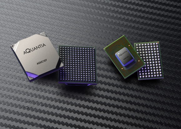 Two pairs of semiconductor chipsets against a textured dark grey background.