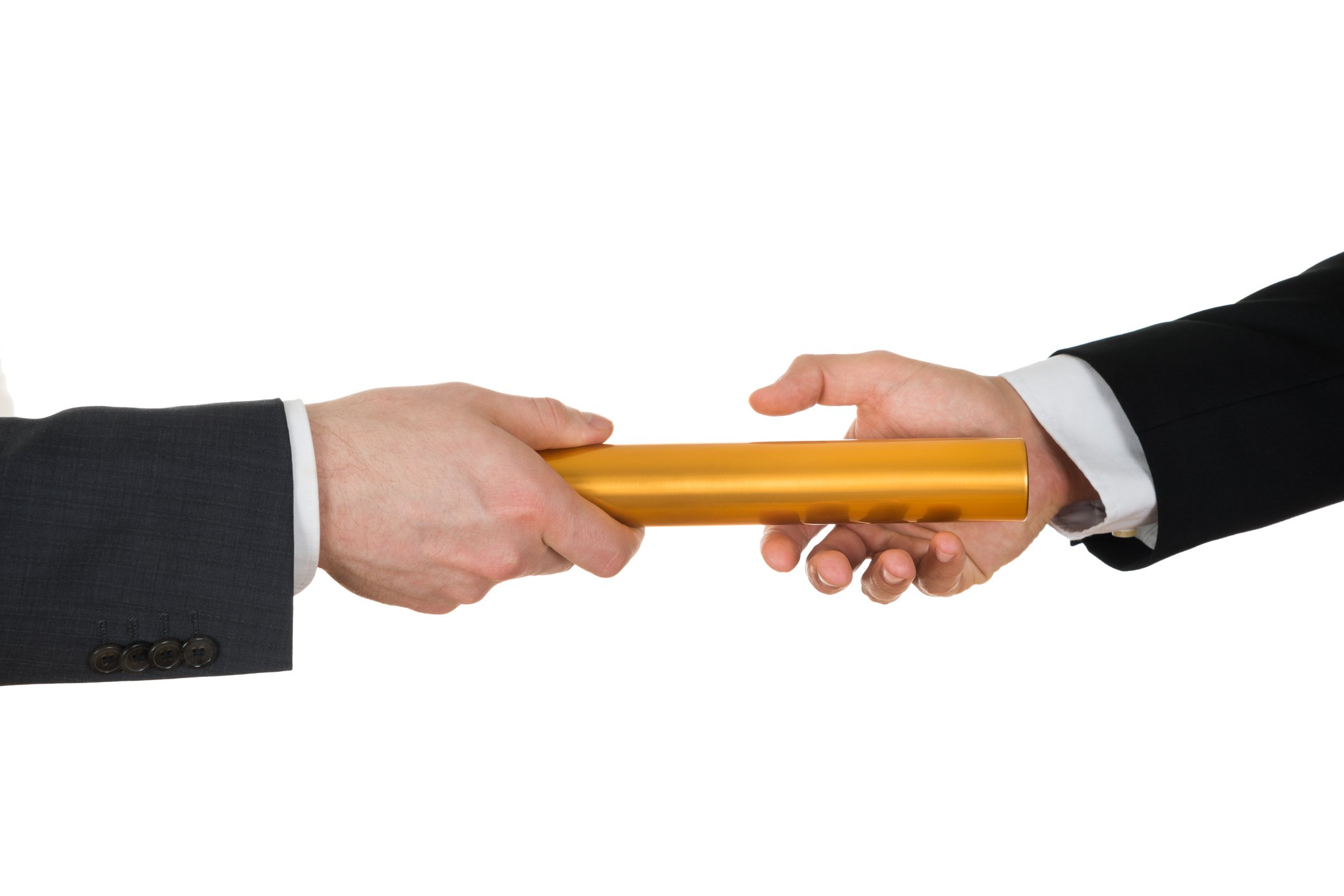 One hand passes a golden baton to another suit-dressed hand.
