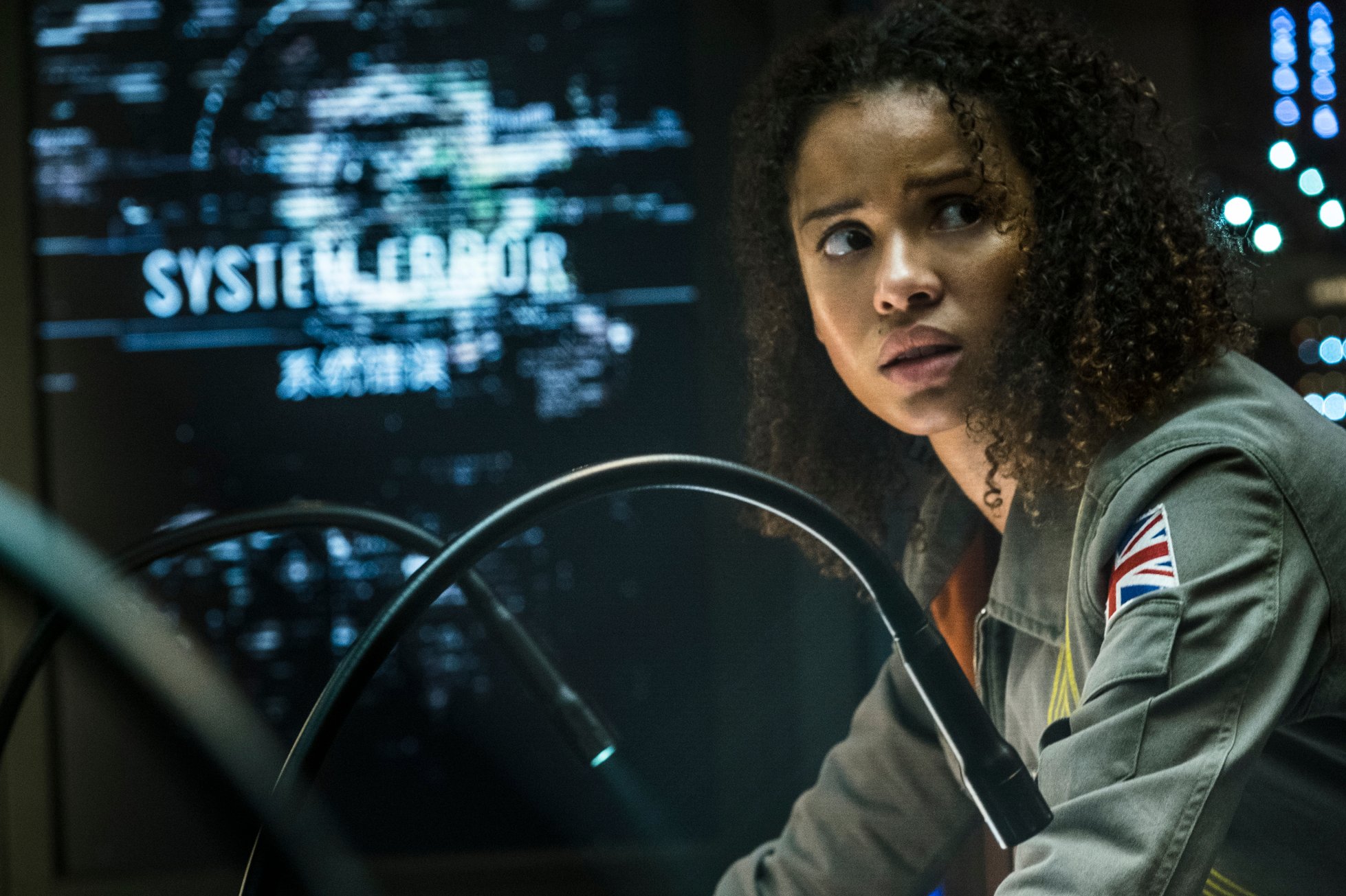 A still from the movie The Cloverfield Paradox, showing a female character with a look of fear and concern.