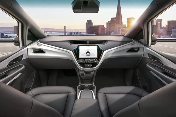 Interior view of GM's driverless car, overlooking a city landscape.