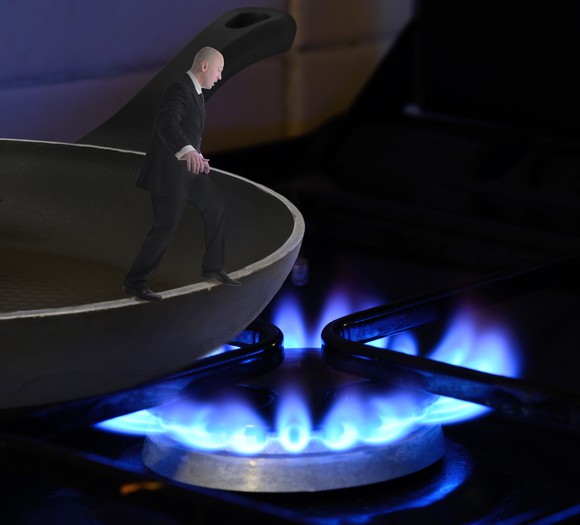 Miniature man stepping of the edge of a frying pan, into the fire.
