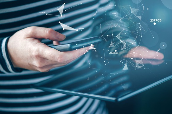 A depiction of cloud connections hovering over a smartphone and tablet.