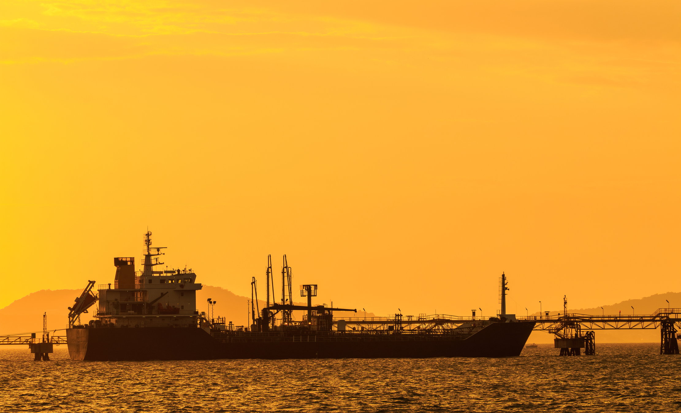 Tanker getting loaded at sunset