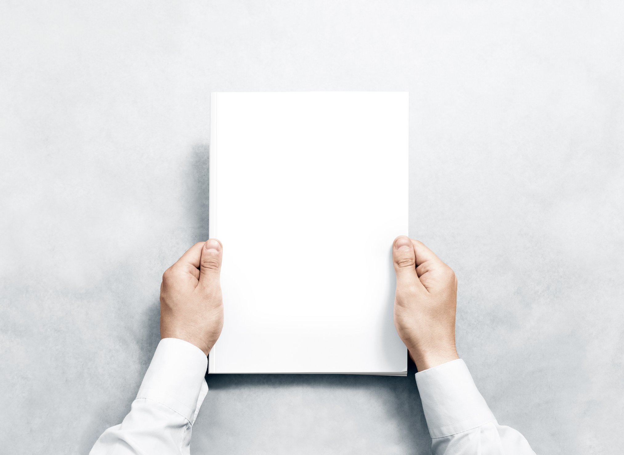 Hands hold a blank piece of paper.