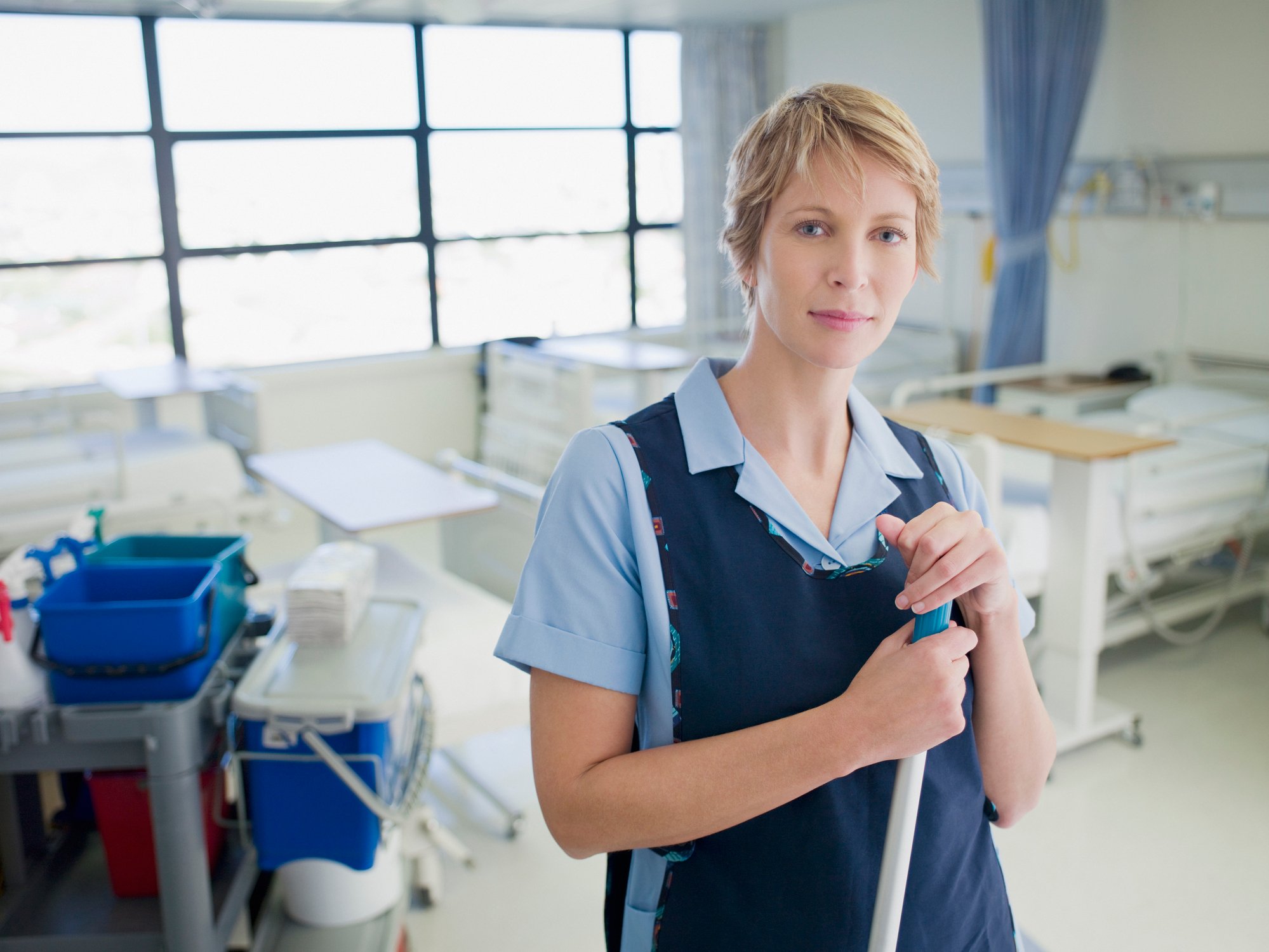 Woman janitor standing in hospital room