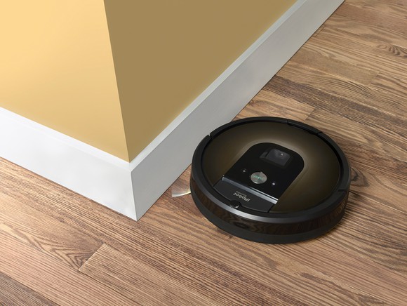 iRobot Roomba 980 rounding a corner on a hardwood floor