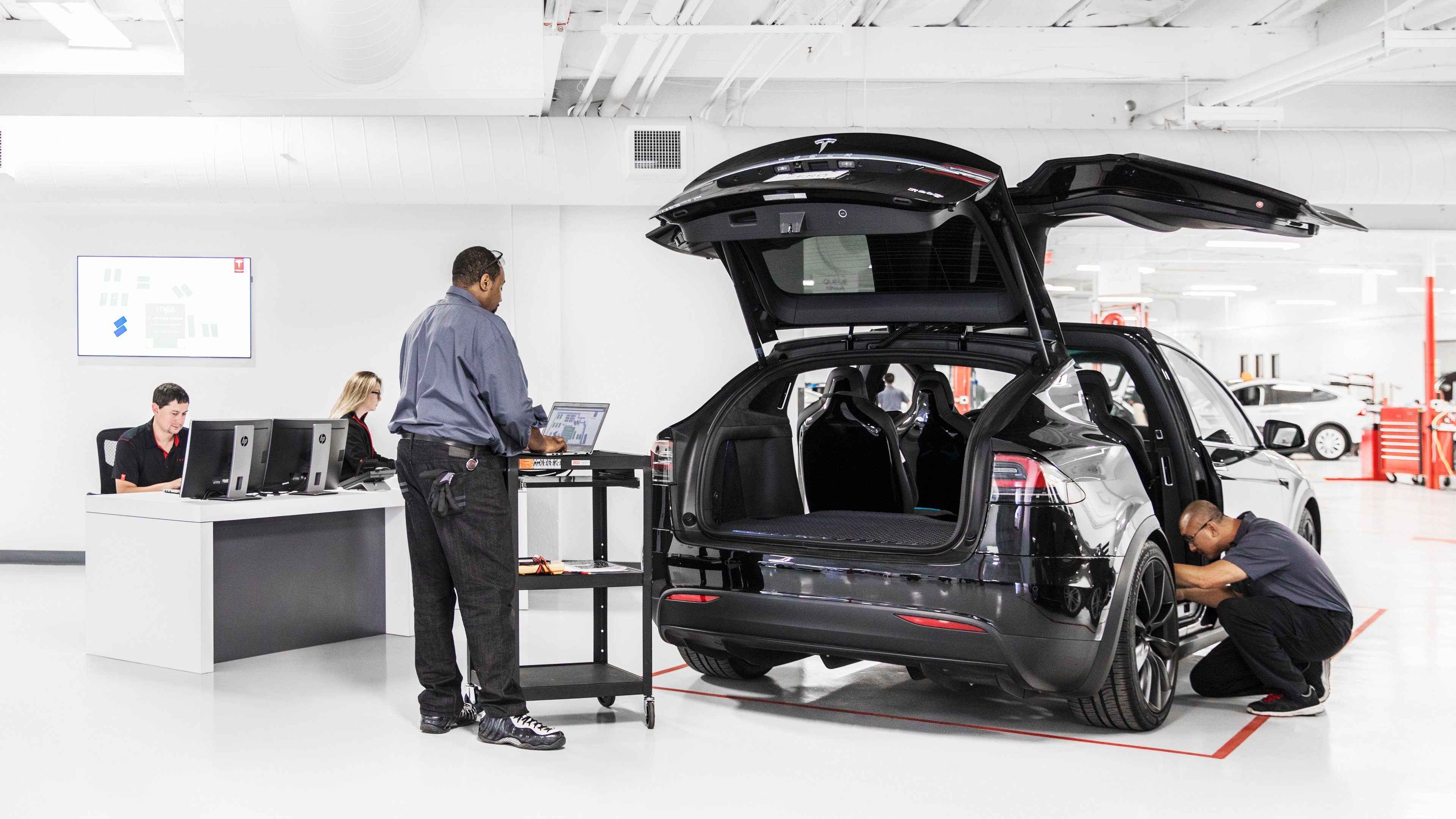 Tesla mechanics working on a Model X
