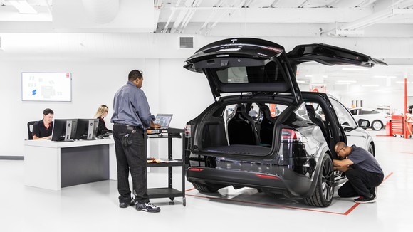 Tesla mechanics working on a Model X