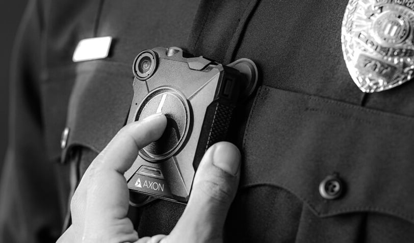 A police officer wearing an Axon body camera.