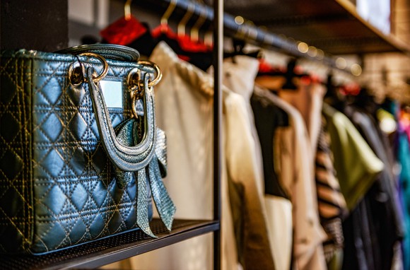 A purse on a shelf in a luxury consumer goods store.