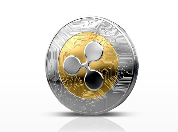 A physical coin with the Ripple logo on it.
