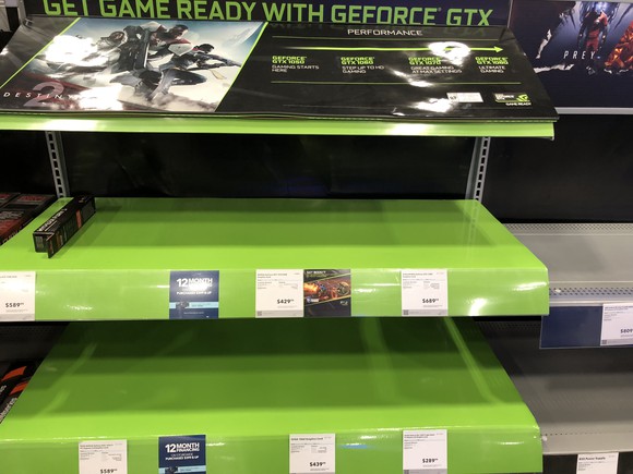 Three empty, bright lime-green shelves in a store