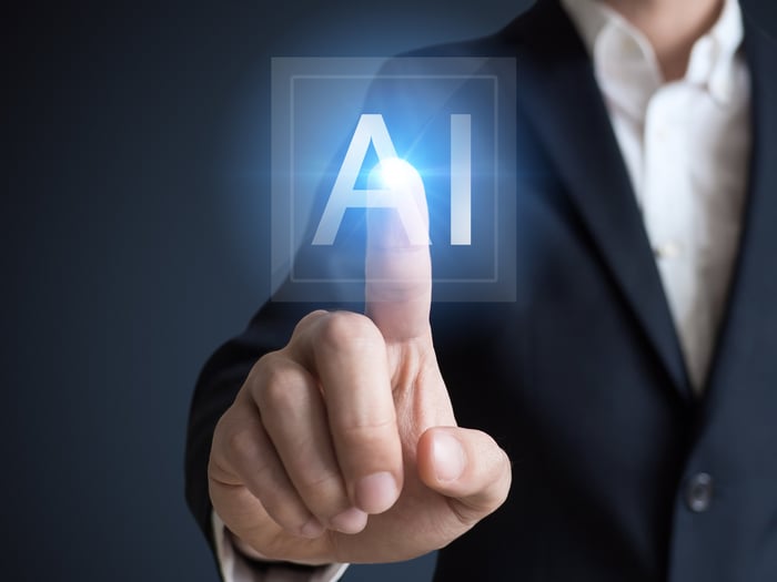 A man pointing to the AI icon with his right forefinger.