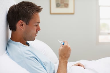 man looking at thermometer_GettyImages-107429738