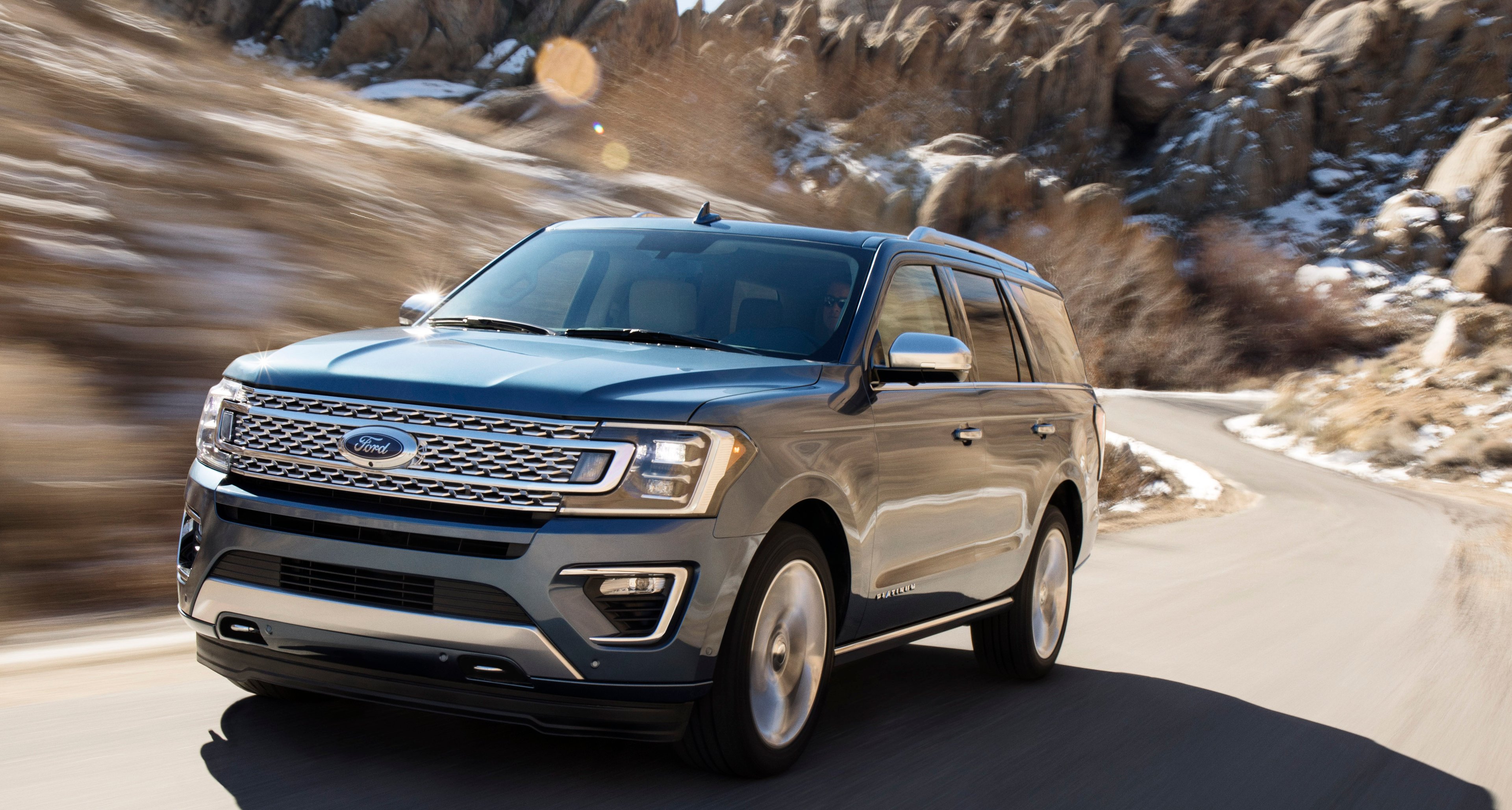 A 2018 Ford Expedition, a big SUV, on a mountain road.