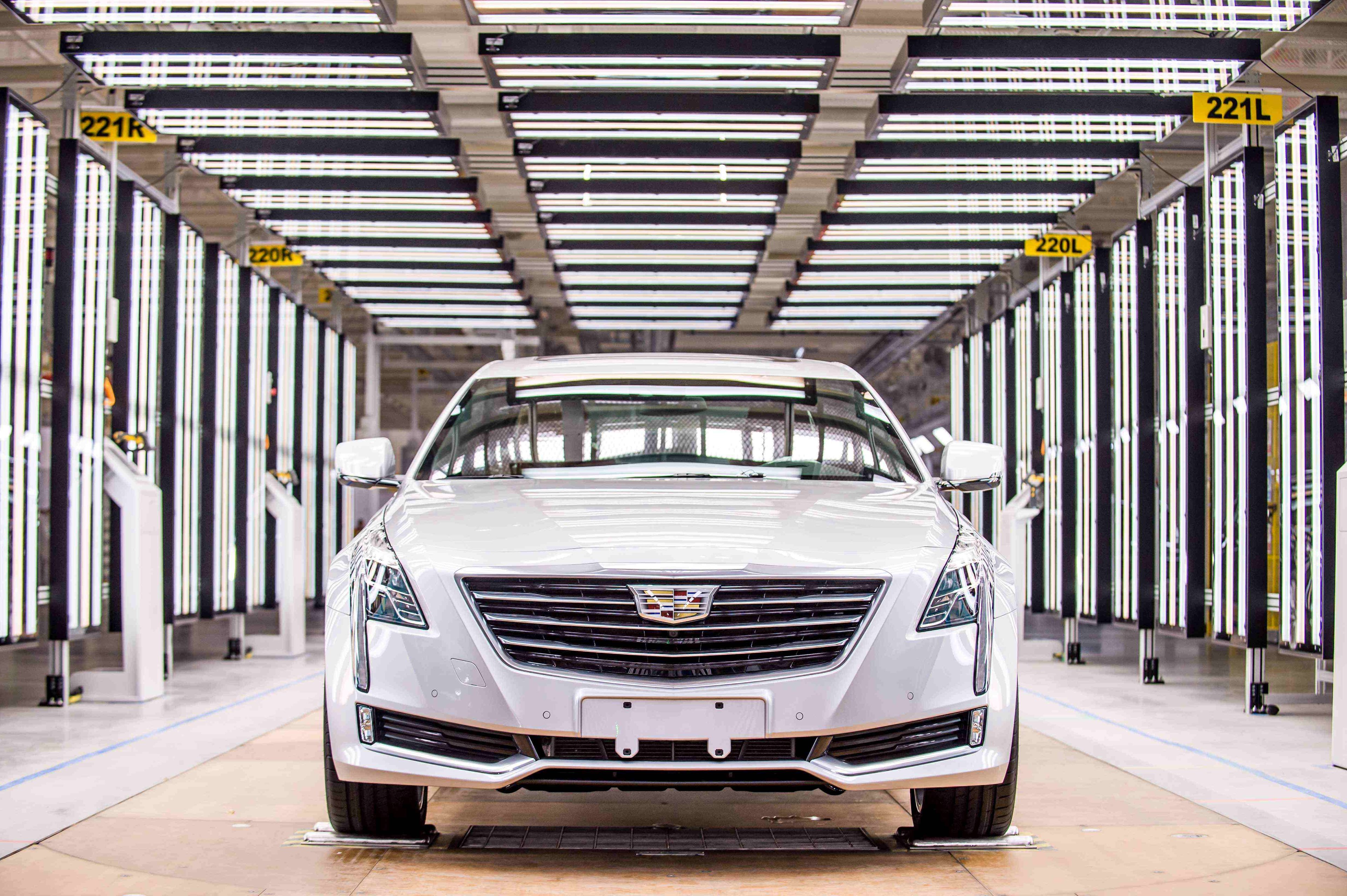 A white Cadillac CT6 luxury sedan in the final inspection area of GM's Shanghai factory.