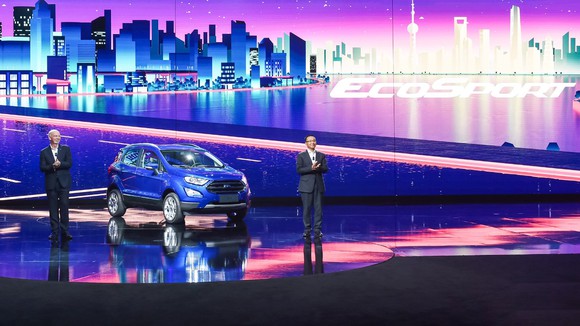Two Ford executives standing next to the new EcoSport on stage.